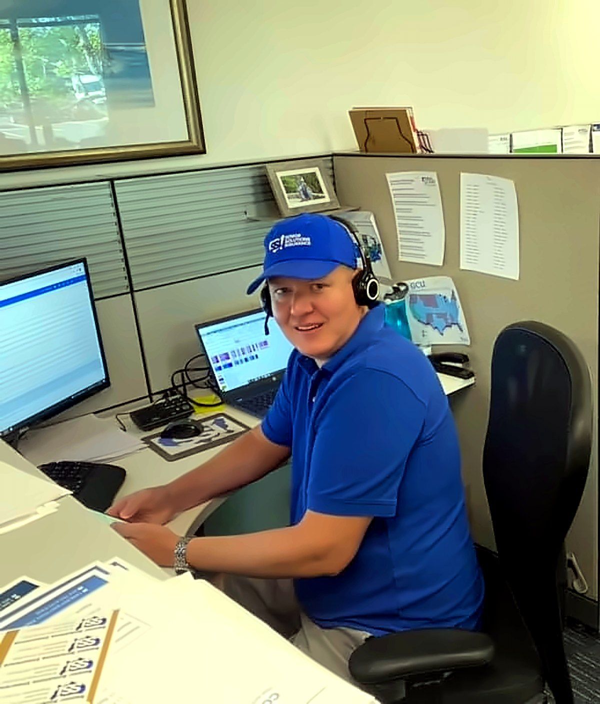 A Senior Solutions agent on a headset at his desk