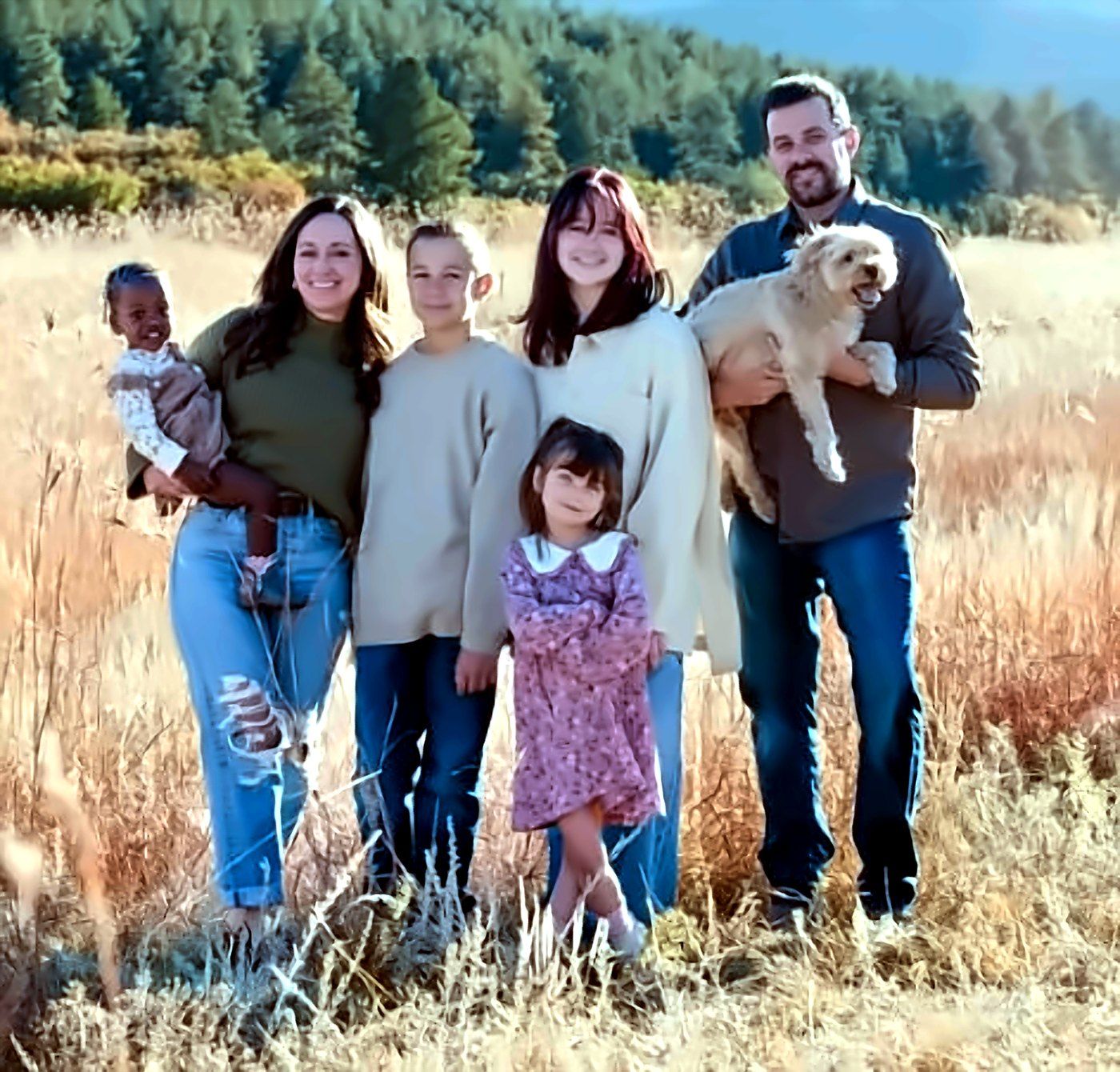Chris Martin with his wife Sarah, their four children and the family dog in a Colorado meadow