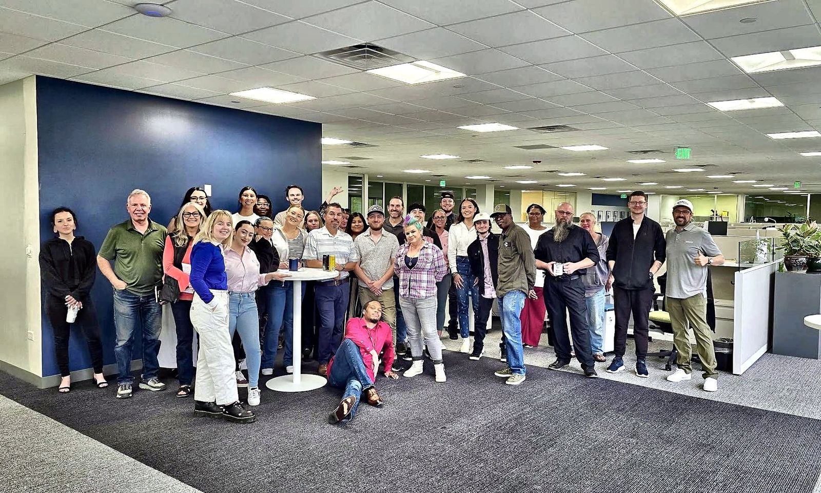 The whole Senior Solutions team standing together in the office